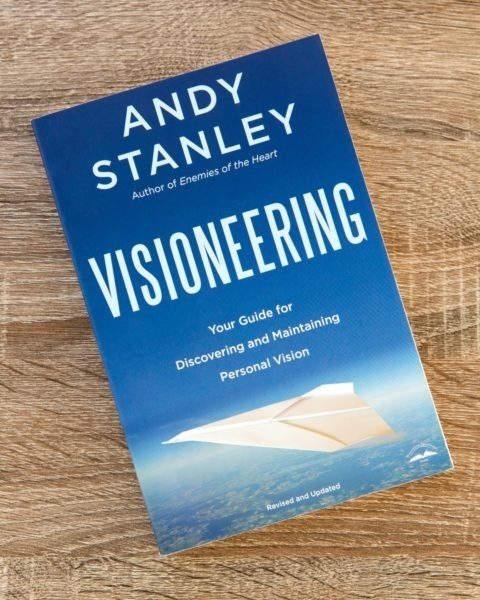 Book cover of "Visioneering" by Andy Stanley, blue cover with paper airplane graphic and subtitle "Your Guide for Discovering and Maintaining Personal Vision."